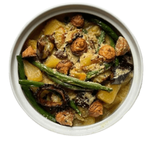 A bowl of traditional Bengali Shukto, served with steaming rice